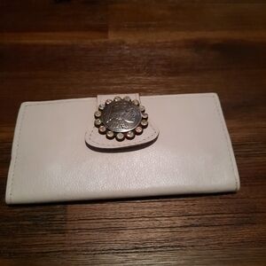Elegant Cream Wallet with Decorative Clasp